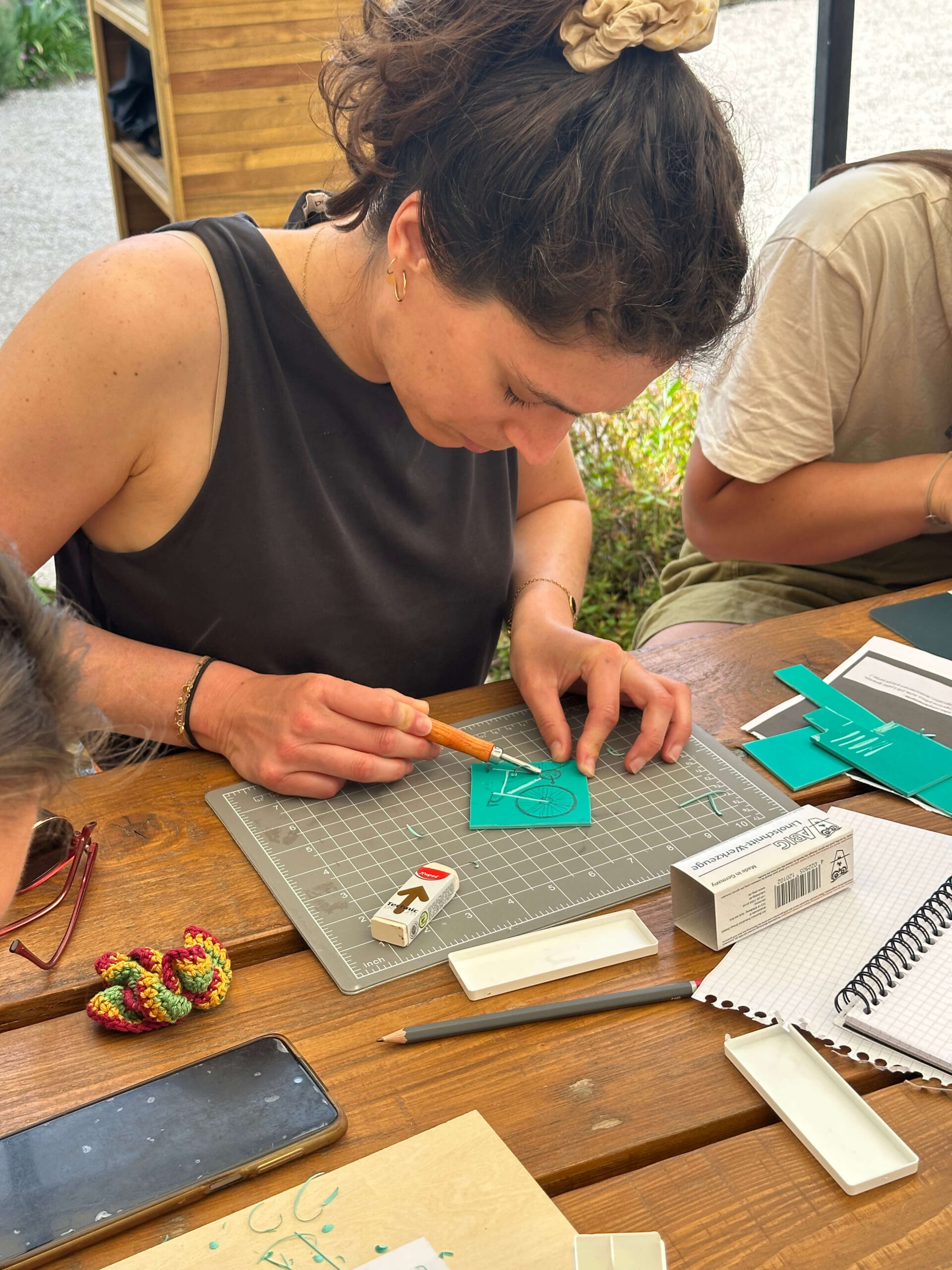 Participante gravant un vélo lors de l'atelier linogravure pour un EVG